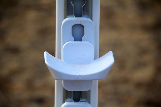 Equestrian jump setup featuring keyhole tracks, jump cups, and safety release adapters for enhanced rider and horse safety.